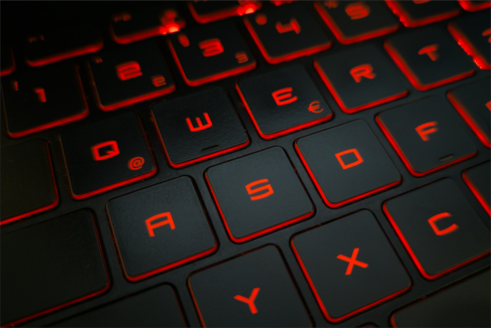 A close-up of red-lit keyboard keys